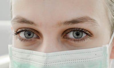 Close-up of a woman's face wearing a mask