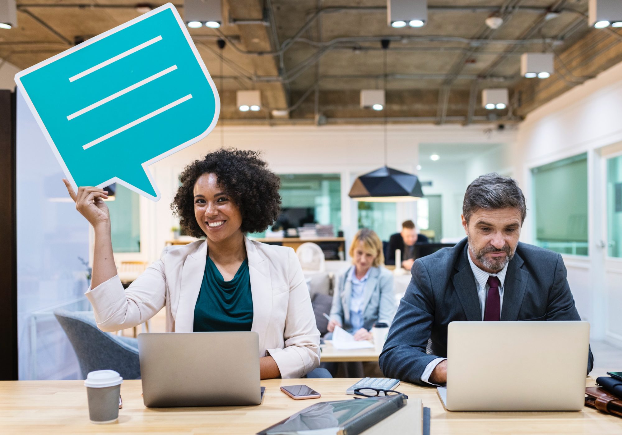 Woman with a thought bubble sitting beside a man looking at his laptop
